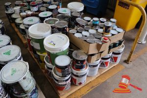 Pallet Of Various Paint Cans And Buckets, Various Sizes, Includes: Dulux Concrete & Paving Paint, Dulux Aquanamel, Taubmans, Various Others, Some Damaged And Leaking, On A Pallet