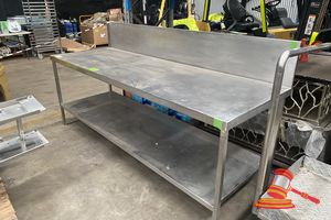 40 · STAINLESS STEEL WORK BENCH WITH SPLASHBACK. APPROX; 2.4M W X 80CM D X 90CM H. SOME MARKS