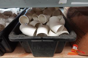 Box Of Assorted White Pvc Elbow Fittings Of Various Sizes