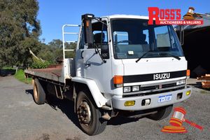 1 · 1991 Isuzu 4x2 Flat Deck Truck (Licenced as Tip Truck) *Registration No# W1141, lic to: 30/09/2026 *Vin No. JALFVR13HK3800126 *Engine No. 6SA1620109 *Model 900 Medium/ FVR13HRN *Kms Showing 329,098 *Engine Capacity 8.4Litre *6 Speed Manual Transmission *Air Conditioned, Power Steering, Air Brakes *Steel Deck Tray Size 5.4metres x 2.4Metres *Tyres: Steers 295/80R22.5 @ 90% Drives 11R22.5 @ 90% *ISRI Seats *24Volt (Twin Batteries) Note: Ex Tip Truck & Tipper PTO Included (Some Corrosion on Steel F