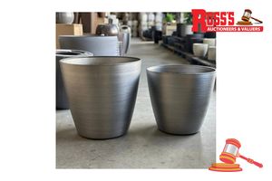 104 · Matching set of 2 Brushed Steel Planters - Sizes: 50 x 48 cm, Size: 43 x 41 cm, RRP $270 Create a stylish designer display from the 2001 Brushed Steel Pot range, featuring a round tapered planter with a brushed steel finish, this range brings a clean, contemporary look to homes, patios, courtyards, entryways and landscaped spaces. Constructed from stone-resin composite: 50% stone, 45% high-density resin and 5% fibreglass, it combines practical lightweight handling with a premium look. It is desi