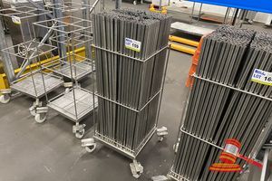 159 · APPROX 300 X STAINLESS STEEL HANGING/DRYING RODS (LENGTH 1000MM) IN STORAGE DOLLY