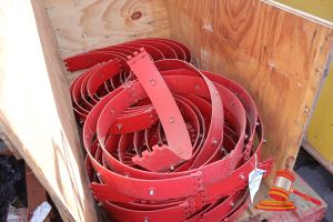 136 · APPROX 20 X RED STEEL PIPE CLAMPS WITH CASTELLATED ENDS, SOME MARKS, IN A WOODEN CRATE, APPROX; 1.2M W X 760MM D X 890MM H, ON A PALLET (NO REF)