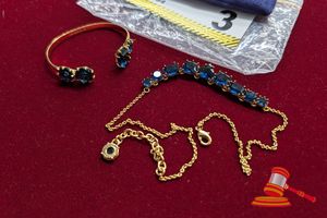1 X YELLOW METAL BANGLE MARKED LES NEREIDIS (SMALL) WITH 4 X BLUE STONES, 1 X MATCHING YELLOW METAL NECKLACE MARKED LES NEREIDIS WITH 9 X BLUE STONES
