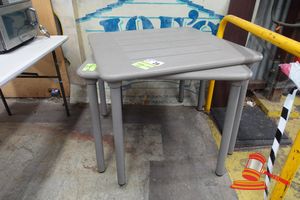 2 X Fawn/Brown Cafe Tables. Plastic With Removable Aluminium Legs. Approx 900 X 900 X H750mm. Some Marks/Stains/Scratches. 1 X Table Damaged