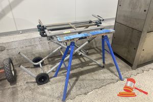 176 · 1 X HITACHI FOLDING MITRE SAW TROLLEY. DECK APPROX 910 X 450MM (POOR CONDITION) AND 1 X SAW HORSE