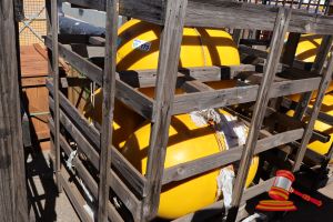 173 · 3 X YELLOW BOUYS WITH HOOK ATTACHMENT, APPROX; 800MM L X 410MM D, SOME MARKS, IN A WOODEN CRATE,