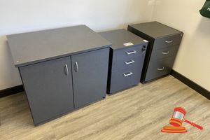 1 X 2 Door Cabinet. Dark Grey Laminate. Approx 840 X 600 X H730mm. Drill Holes In Top, 1 X 3 Drawer Mobile Cabinet. Dark Grey Laminate. Approx 510 X 510 X H680mm , 1 X 3 Drawer Mobile Pedestal Cabinet. Dark Grey Laminate. Approx 480 X 500 X H650mm